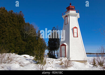 Canada, Ontario, Tobermory. Lighthouse on Georgian Bay in winter. Stock Photo