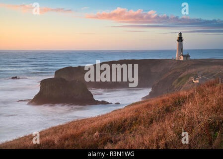 Photo of the Yaquina Head Lighthouse in Oregon at the sunset time Stock Photo