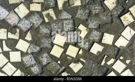 Dirty old colored small ceramic tiles. Texture, background.Broken ceramic mosaic on a concrete basis. Stock Photo