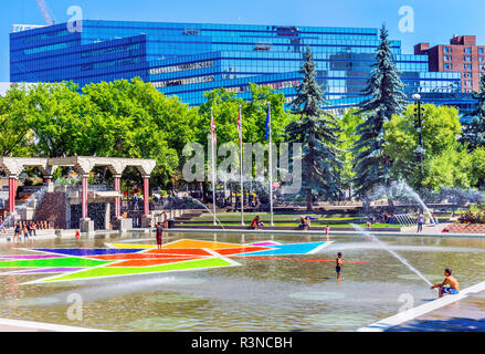 Children playing on Olympic Plaza fountains. Downtown Calgary, Alberta, Canada. Olympic Plaza was created in 1988 for Olympic Winter Games. Stock Photo