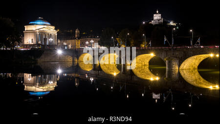 Ponte Umberto I, bridge over the River Po. in the centre of Turin Italy. The Church of Gran Madre can be seen over the bridge. Photographed at night. Stock Photo