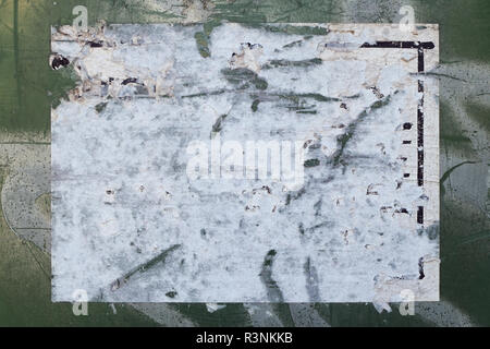 Torn paper sticker on textured scratched and painted surface. Abstract background. Stock Photo