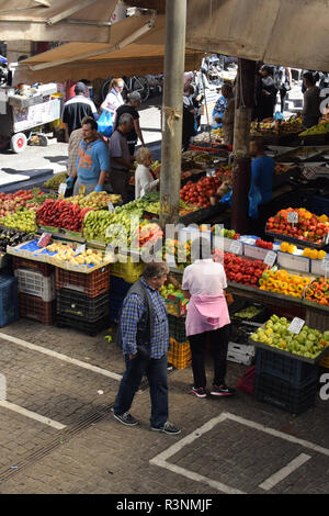 ATHENS, GREECE - OCTOBER 2, 2018: People buying fresh fruit and vegetables at farmers market.