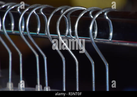 plastic hangers detail shot, metal clothes hangers on clothes rail macro shot Stock Photo