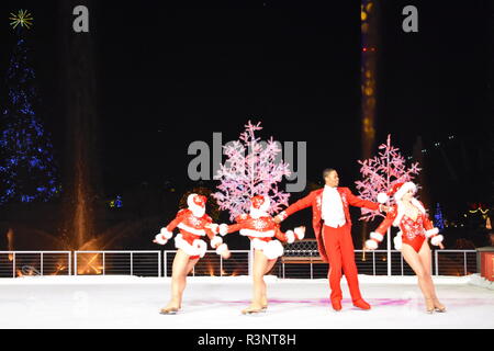 Orlando, Florida. November 20, 2018 Artists skating on ice rink at Christmas Show on holidays trees background in International Drive area. Stock Photo