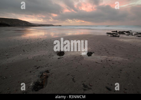 Sunrise over Kennack Sands Beach on the Lizard Coast of Cornwall Stock Photo