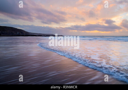 Sunrise over Kennack Sands on the Lizard Coast of Cornwall Stock Photo