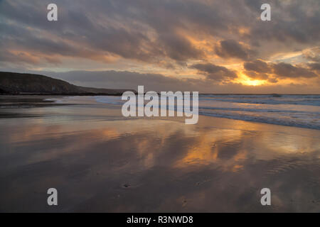 Sunrise on Kennack Sands beach on the Lizard Coast of Cornwall Stock Photo