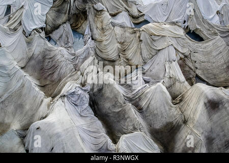 Climate | Albedo | Rhone: Huge fleece blankets cover parts of the Rhone Glacier in Switzerland in an attempt to stall the inevitable melting of the snow and ice. After a winter with record amounts of snow, most of it was gone when this image was taken on July 14th 2018, exposing the darker ice. While snow is a brilliant reflector of the energy from the sun, the darker ice absorbs the energy instead, accelerating the melting of the glacier. The color and darkness of glacier ice vary all over the world, depending on build-up of pollution, age of the ice, particles picked up by the ice and by mic Stock Photo