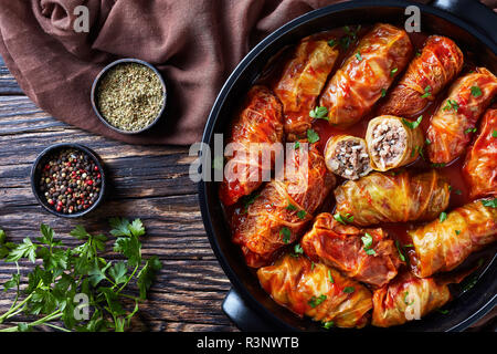 overhead view of cabbage rolls stuffed with ground beef and rice and baked to perfection with a tangy tomato sauce in dutch oven, flatlay, close-up Stock Photo