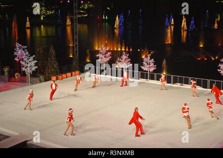 Orlando, Florida. November 20, 2018. Professional Skaters doing a round during Christmas Show on ice at night in SeaWorld Stock Photo