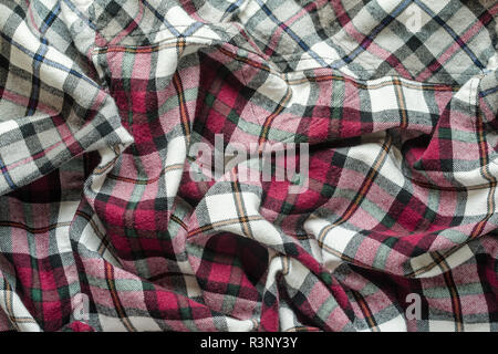Wrinkled plaid fabric. Background crumpled cloth in a cage Stock Photo