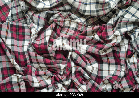 Wrinkled plaid fabric. Background crumpled cloth in a cage Stock Photo