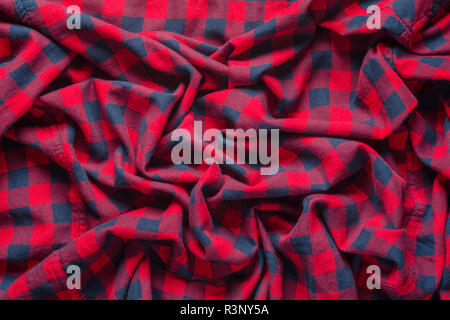 Wrinkled plaid material. Red dark blue checkered shirt cloth background. Stock Photo