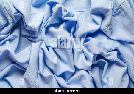 Wrinkled texture of light blue fabric for shirts. Blank textile background Stock Photo