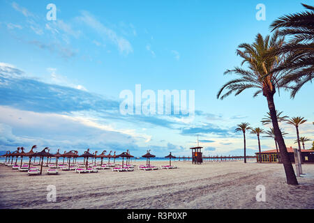Wide angle view of an empty beach at sunrise, color toned picture, Mallorca, Spain. Stock Photo