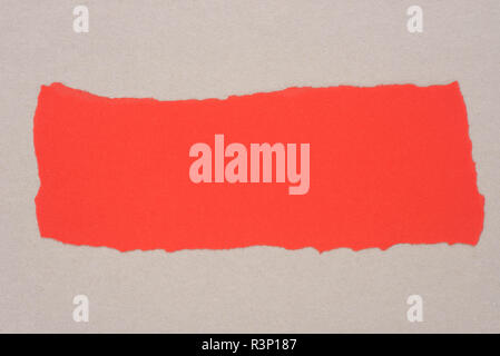 red color piece of torn paper on gray background texture Stock Photo