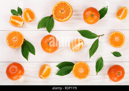 orange or tangerine with leaves on white wooden background. Flat lay, top view. Fruit composition Stock Photo