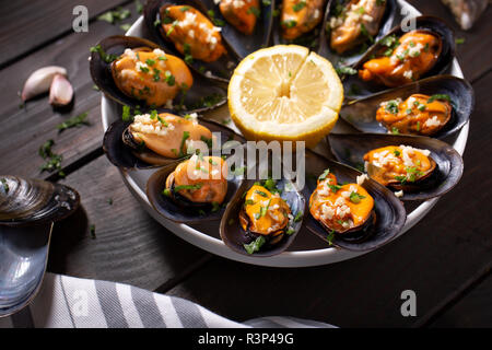 Cooked Mussels. Steamed mussels in white wine sauce with parsley and garlic. Tasty spanish seafood recipe. Close up