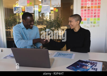 Business executives shaking hands with each other Stock Photo