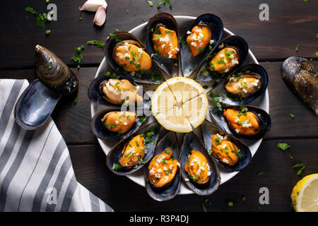 Cooked Mussels. Steamed mussels in white wine sauce with parsley and garlic. Tasty spanish seafood recipe. Top view