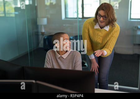 Business executives talking with each other in office Stock Photo