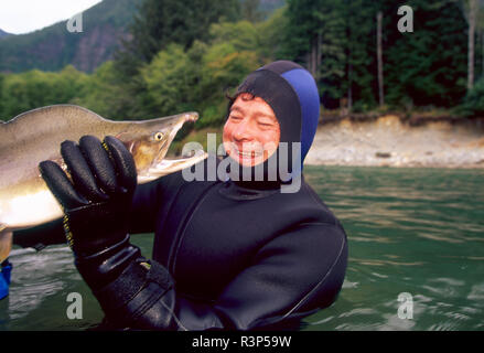 Scientist holding large Chinook Salmon, Vancouver Island, British Colombia (MR) Scientist holding large Chinook Salmon, Vancouver Island, British Colombia (MR)