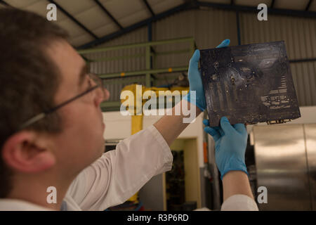 Robotics engineer checking circuit board Stock Photo