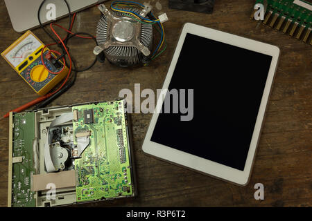 Digital tablet and circuit board on table Stock Photo