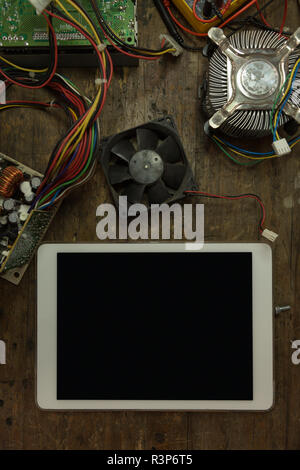 Digital tablet, circuit board and computer fan on table Stock Photo