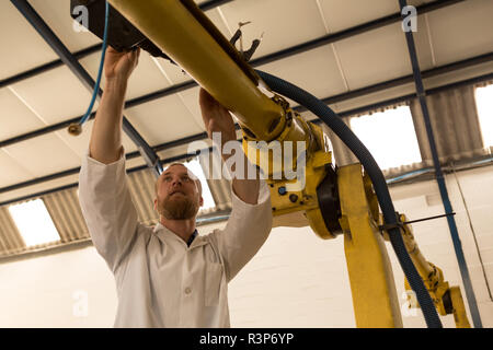 Robotics engineer operating robotic machine Stock Photo