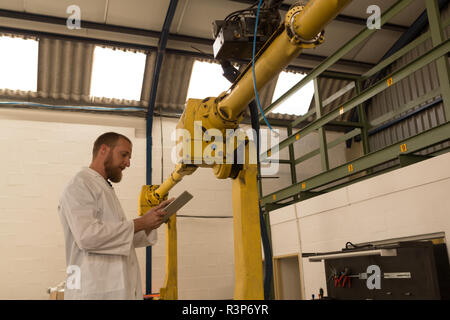 Robotics engineer using digital tablet Stock Photo