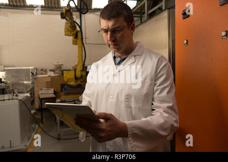 Robotic engineer using digital tablet Stock Photo