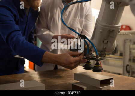 Robotic engineers testing robotic machine Stock Photo