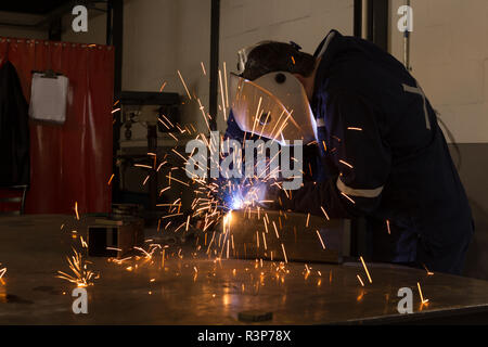 Robotic engineers using welding torch Stock Photo