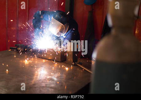 Robotic engineers using welding torch Stock Photo