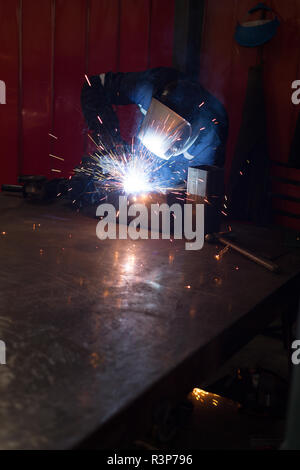 Robotic engineers using welding torch Stock Photo