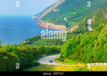 Canada, Nova Scotia, Cape Breton Highlands National Park. Vehicle on winding Cabot Trail road. Stock Photo