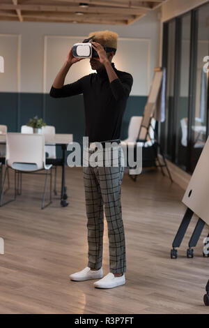 Businessman using virtual reality headset Stock Photo