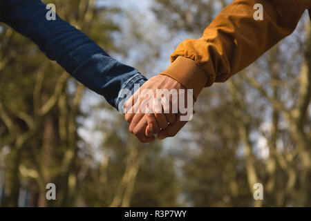 Couple holding hands in city Stock Photo