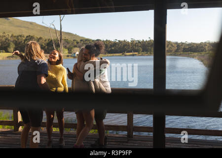 Friends hugging each other in cabin Stock Photo
