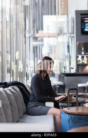 Businesswoman using digital tablet on sofa Stock Photo