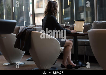 Businesswoman using laptop in hotel Stock Photo