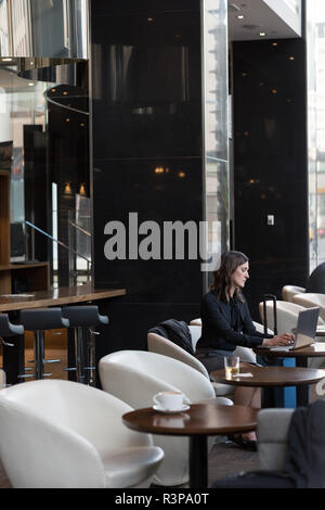 Businesswoman using laptop in hotel Stock Photo