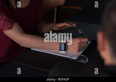 Businesswoman writing on notepad in conference room Stock Photo