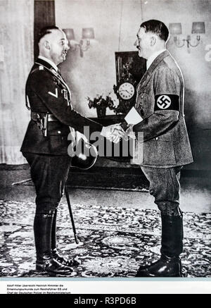 Berlin, Germany. A photo of Adolf Hitler shaking hand with Heinrich Himmler, head of the SS and Gestapo in Hitler's office. (Editorial Use Only) Stock Photo