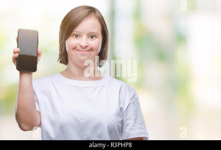 Young adult woman with down syndrome showing smartphone screen over isolated background with a happy face standing and smiling with a confident smile  Stock Photo