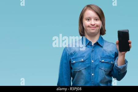 Young adult woman with down syndrome showing smartphone screen over isolated background with a happy face standing and smiling with a confident smile  Stock Photo