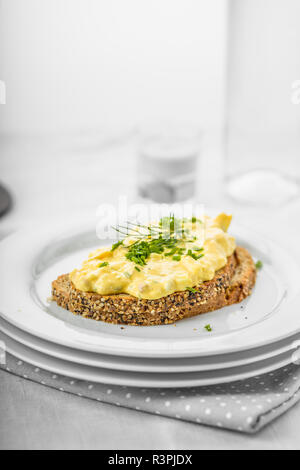 Fresh egg salad with chives and bacon on whole wheat bread Stock Photo