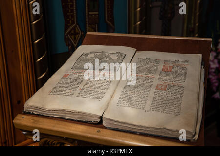 Old Christian manuscript written in Cyrillic on church pulpit. Stock Photo